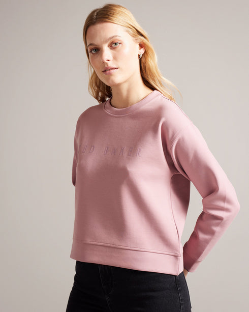 LIVANAA-Tops-Who says you can't be comfortable and chic? With a crew neck, long sleeves and embossed logo detail, LIVANAA is the staple sweatshirt that your wardrobe has been craving. Sweatshirt Embossed Ted Baker logo Crew neck Long sleeves Ayo is 5'8" / 1.73m and wears Red in a Ted size 1- Ted Baker Romania